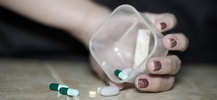 An image of a person holding their head in their hands, looking overwhelmed and stressed, with various healthcare and stress management tools surrounding them.