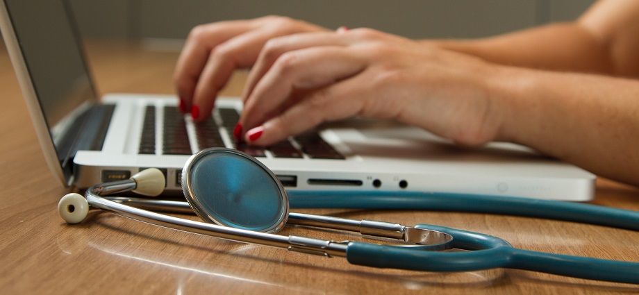 Image of a healthcare provider using an EHR system to access patient medical records.